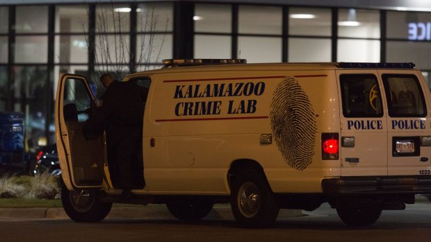 An officer with the Kalamazoo Crime Lab leaves the scene of one of the random shootings.
