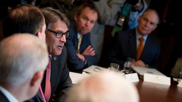 Energy Secretary Rick Perry, centre left, accompanied by Budget Director Mick Mulvaney, centre, and Scott Pruitt, right, speaks during a cabinet meeting last month.