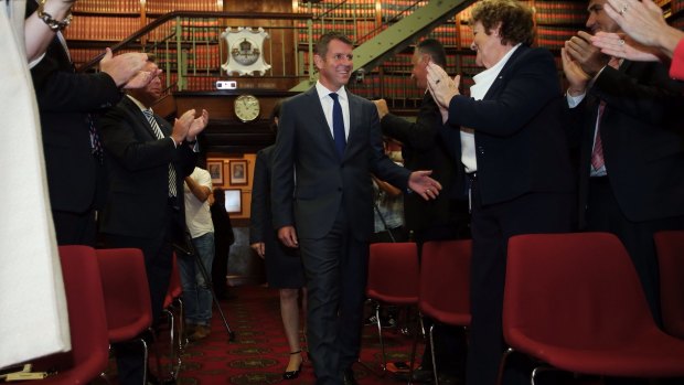 NSW Premier Mike Baird is congratulated as he enters a party room meeting of the NSW Liberal Party on Wednesday.