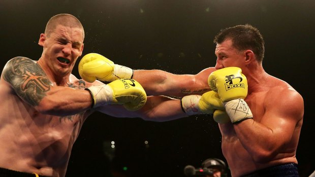 Punching on: Paul Gallen throws a right at Randall Rayment during their heavyweight bout during the Footy Show Fight Night at Allphones Arena on January 31, 2015.