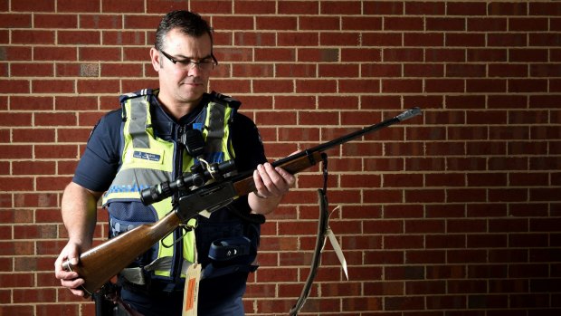 Leading Senior Constable David Jenkin - seen here with a gun seized from illegal deer hunters - is a serving officer in rural Victoria.