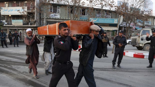 Four men carry the coffin from a deadly suicide attack in Kabul, Afghanistan.