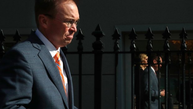 Mick Mulvaney walks to the Eisenhower Executive Office Building after leaving the Consumer Financial Protection Bureau in Washington on Monday.