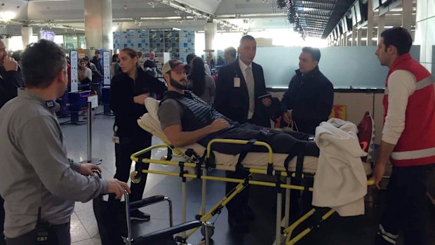 William Raak, a Delaware business owner, is helped to his plane at Ataturk Airport in Istanbul on Monday. Mr Raak was shot in the leg during the Istanbul nightclub attack on New Year's Eve.