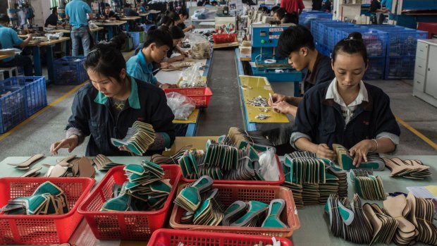 Workers on the assembly line at the Huajian shoe factory in Dongguan, China, where shoes for Ivanka Trump's company have been produced.