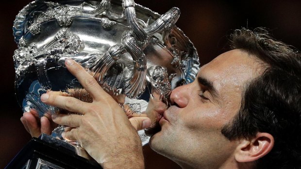 Switzerland's Roger Federer holds his trophy aloft.