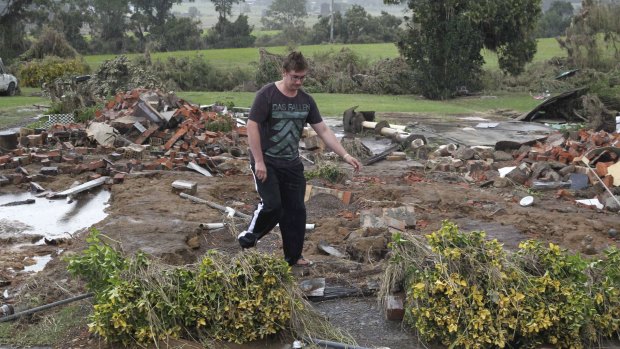 Keegan Jones sifts through what's left of where his house once was.
