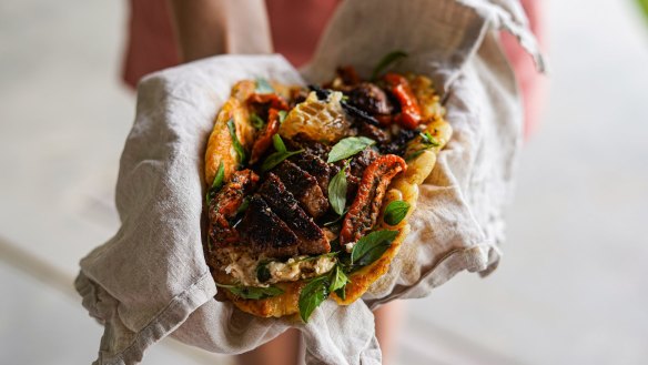 Flatbread loaded with coffee spice-rubbed lamb, honey and feta.