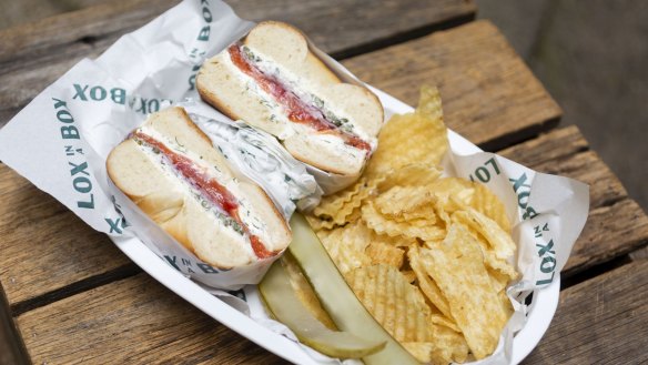 Classic lox bagel with pickles and chips.