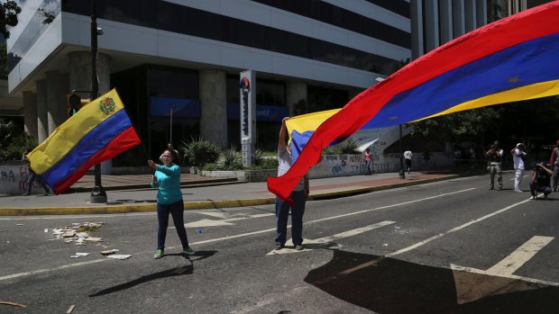 Anti-government demonstrators wave Venezuelan national flags during a protest against Venezuela's President Nicolas Maduro in Caracas, Venezuela.