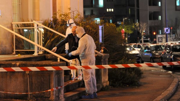 Police collect evidence outside the police station at Joue-les-Tours.