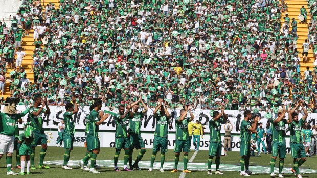 New Chapecoense players applaud prior to a friendly match against Palmeiras.