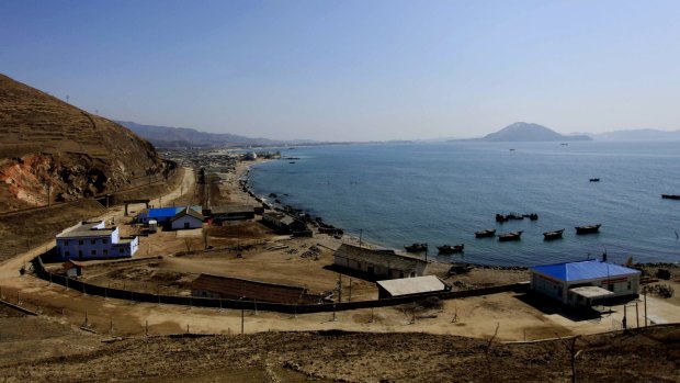 Fishing boats are anchored in a bay in Sinpho, North Korea. North Koreans are being mobilised en masse to boost production and demonstrate their loyalty to Kim Jong-un in a 70-day campaign against "indolence and slackness." 