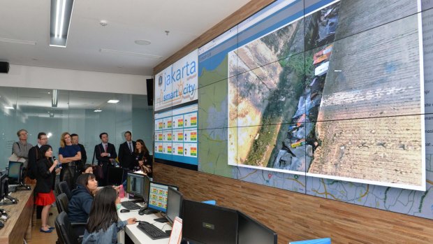 Australian journalists are shown rubbish build-up at a spot in Jakarta being monitored by the Smart City team from city hall.
