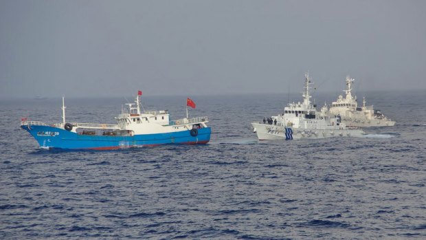 Previous tensions: Japanese Coast Guard patrol boats approach a Chinese fishing boat in 2013.