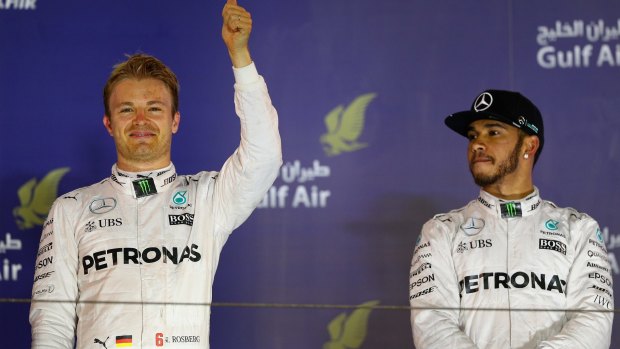 Nico Rosberg celebrates his win on the podium as Lewis Hamilton looks on.