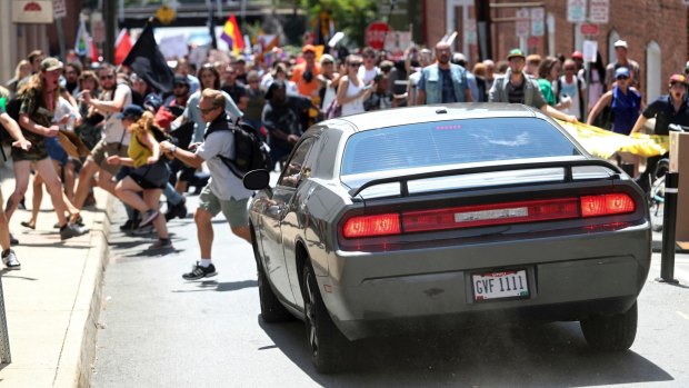 A vehicle drives into a group of protesters demonstrating against a white nationalist rally in Charlottesville.