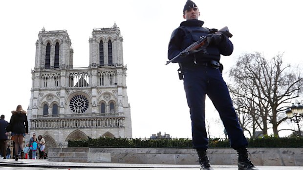 A French police officer stands guard outside Notre Dame cathedral in Paris earlier this year.