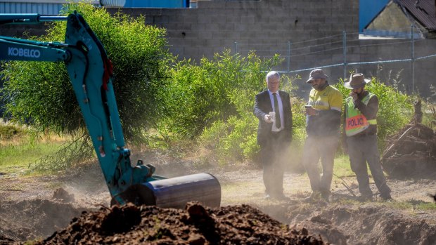 Detective Superintendent Des Bray (left) inspects the dig site at a factory in Plympton, Adelaide.