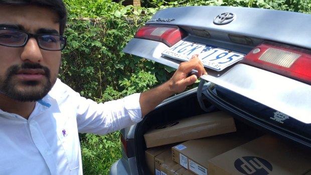 Vocational education salesman "Hamza" and his car full of laptops.