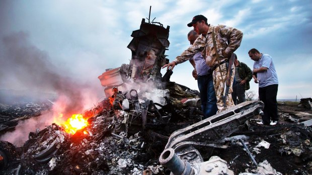 Inspecting the wreckage of a passenger plane, flight MH17, in Ukraine last year.
