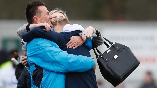 Sutton United's manager Paul Doswell celebrates with family after their victory.