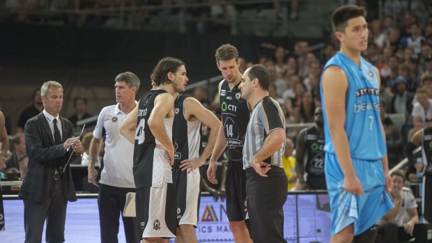 Controversial finish: Play stops while referees ponder the consequences of fouls in the final seconds of the game between Melbourne United and New Zealand Breakers. 