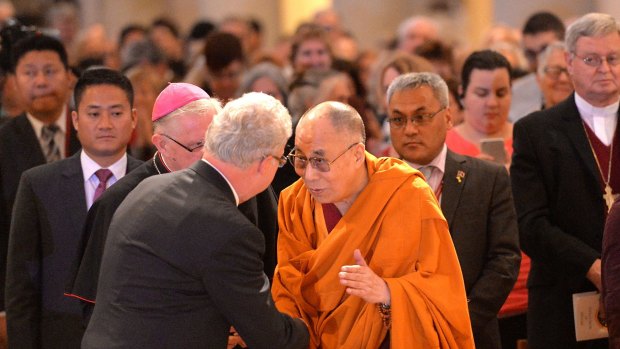 The Dalai Lama greets guests before speaking at Brisbane's Cathedral of St. Stephen for a Prayer for World Peace. 