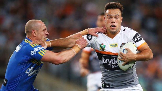 Tiger Luke Brooks attempts to fend off Eels half Jeff Robson in their NRL clash at ANZ Stadium.