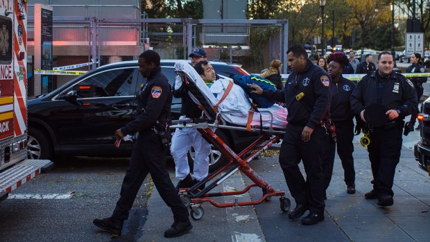 Emergency personnel carry a man into an ambulance after the attack near the World Trade Centre in New York. 
