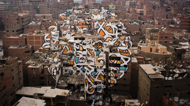 A mural stretched across more than 50 buildings by the artist eL Seed, in the poor Manshiyat Nasser district of Cairo.