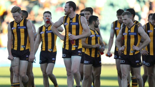 Jarryd Roughead leads his despondent players off the ground after being crushed by the Saints.