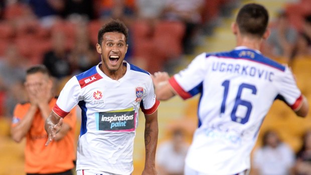 Productive night: Mitch Cooper celebrates scoring a goal for the Jets during their 2-2 draw with Brisbane Roar.