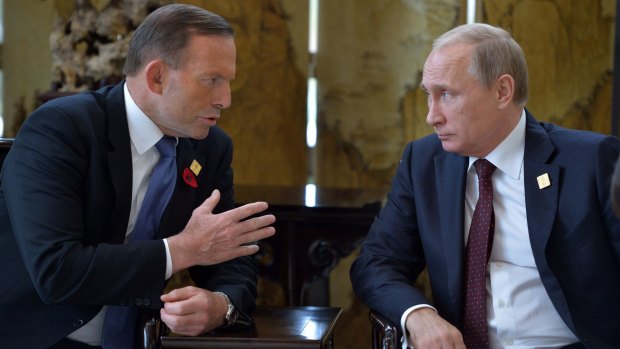 Australian Prime Minister Tony Abbott speaks with Russian President Vladimir Putin at the APEC leaders' summit in Beijing.