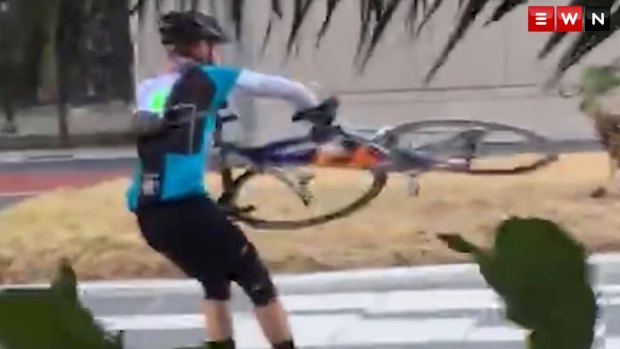 Blowing a gale: A cyclist battles to hold onto his bike against the wind.