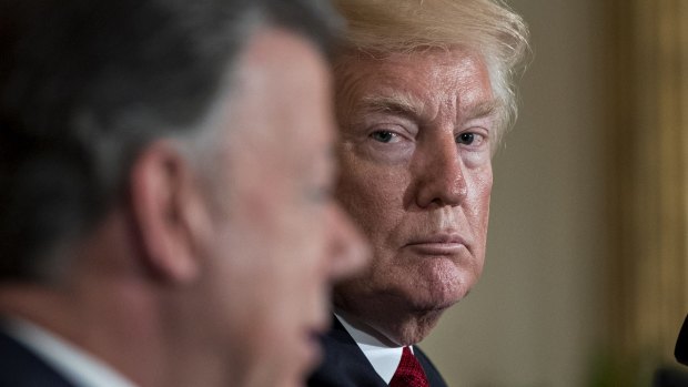 US President Donald Trump listens as Juan Manuel Santos, Colombia's president, left, speaks during a news conference at the White House on Thursday.