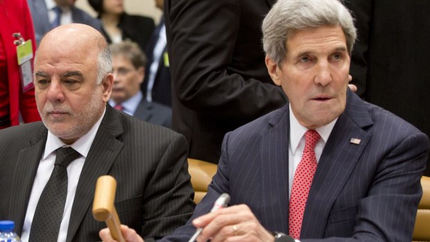 Common enemy: US Secretary of State John Kerry, right, and Iraqi Prime Minister Haider al-Abadi participate in a round table meeting of the global coalition to counter the Islamic State militant group in Brussels.