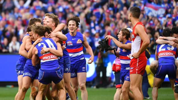 That day last year: Bulldogs players celebrating the grand final win over the Swans.

