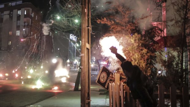 A pro-Kurdish protester launches firecrackers towards a Turkish police water cannon during clashes in Istanbul earlier this month. Turkey imposed curfews in mainly Kurdish towns and districts in December while its security forces battled militants linked to the Kurdistan Workers' Party, or PKK.