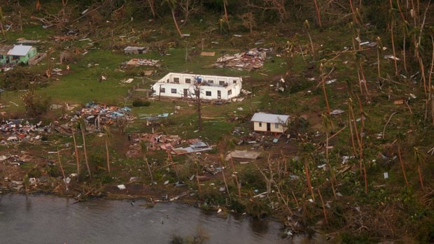 Debris is scattered around damaged buildings at Muamua on Vanua Blava Island in Fiji, after Cyclone Winston tore through the island nation. .