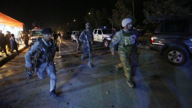Security forces rush to respond to a Taliban attack on the campus of the American University in the Afghan capital Kabul on August 24, nearly three weeks after Timothy Weeks was kidnapped.