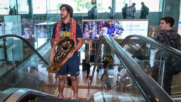 Johnathan Thurston with the winning trophy after the NRL grand final.