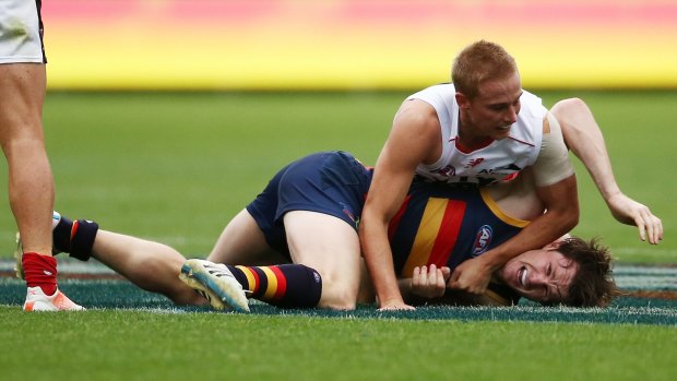 Arm wrestle: The Demons' Bernie Vince and Adelaide's Patrick Dangerfield come to grips last weekend.
