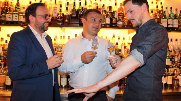 The judges: (from left) David Vitale, Adam Freier and Luke McCarthy go over the options at Melbourne's Whisky and Alement bar.