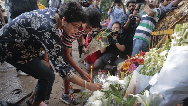 Members of an Indian family lay flowers at the scene of a deadly attack by militants at a bakery in Dhaka in July. 