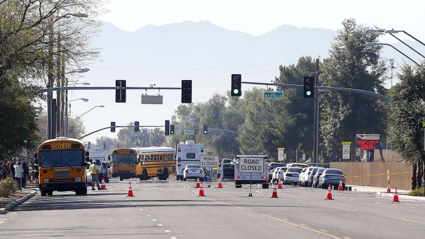 Buses make their way to bring parents waiting to reunite with their children in the Phoenix suburb of Glendale.
