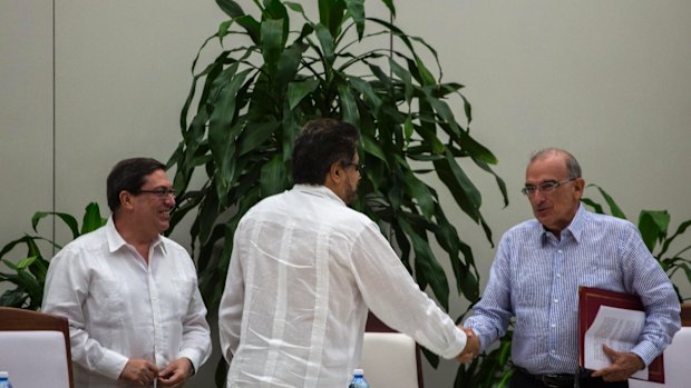 Humberto de La Calle, right, head of Colombia's government peace negotiation team, right, shakes hands with Ivan Marquez, chief negotiator of the Revolutionary Armed Forces of Colombia, or FARC in Havana, Cuba.