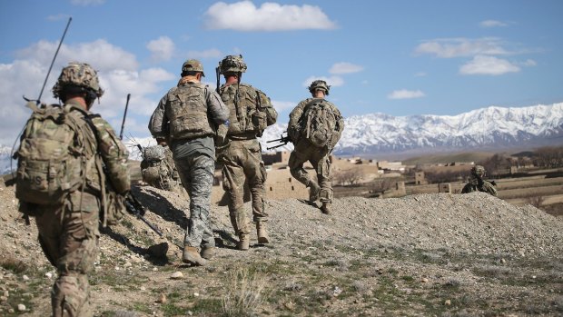 US soldiers patrol a village outside of Forward Operating Base Shank in Afghanistan last year.  