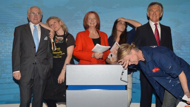 Madam Tussauds Sydney staff Zoe Walton (leaning on John Howard), Crystal Kranz and Jan Cowell (front).