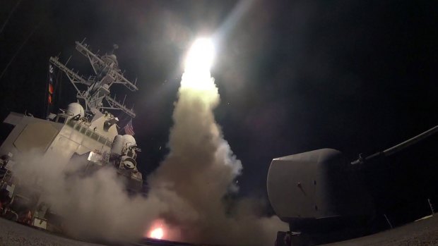 The guided missile destroyer USS Porter launches a Tomahawk missile as the US blasted a Syrian air base with a barrage of cruise missiles.